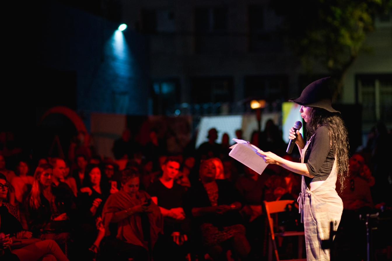 A performer reading into the microphone