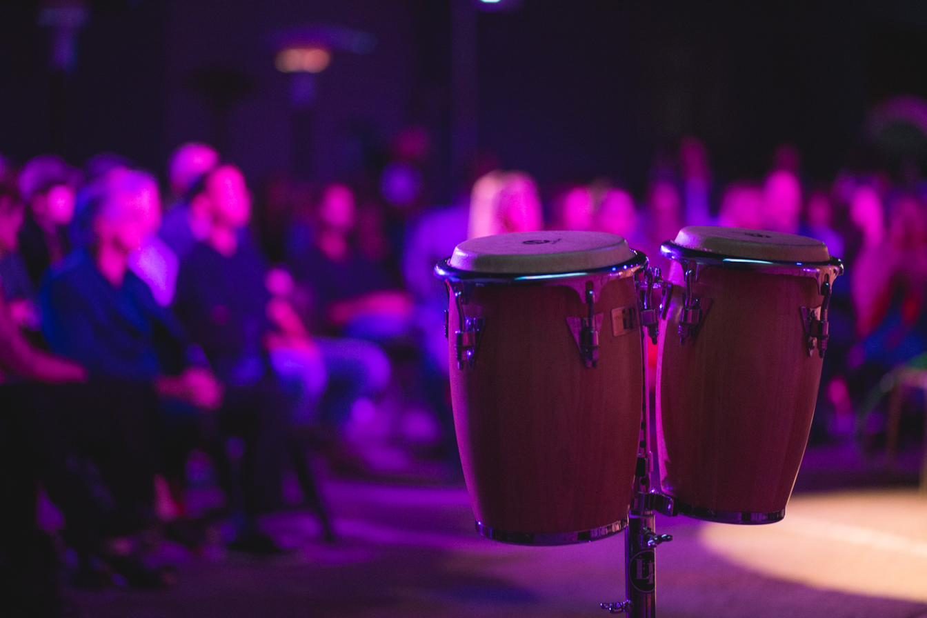 Paint The Mic — congas glowing under stage light